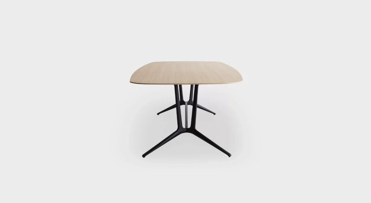 Compact round side table with slim pedestal base by Lapalma.
