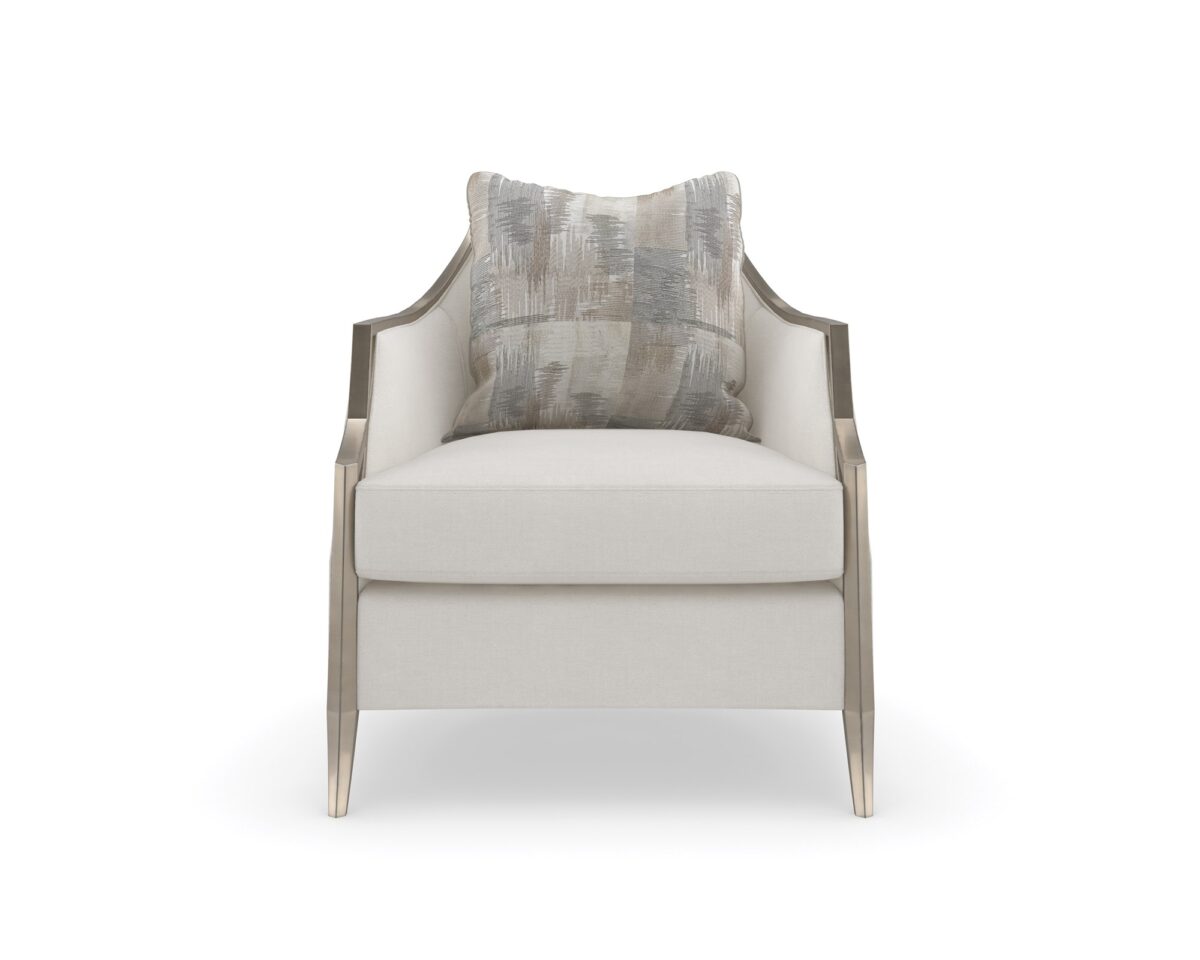 The Caracole X Factor Sofa, a modern classic upholstered in a herringbone performance fabric, featuring a wood-trimmed silhouette with a carved crisscross pattern, gently sloping arms, splayed legs in a metallic Charcoal Leaf finish, and feather-down toss pillows.