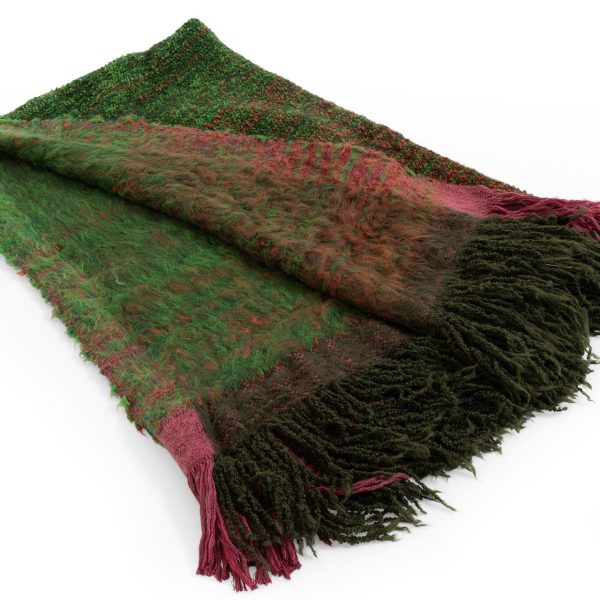 7Plaids Throw by Moroso in hand‑loomed Italian plaid design, draped over a sofa in a Royal Oak Michigan showroom