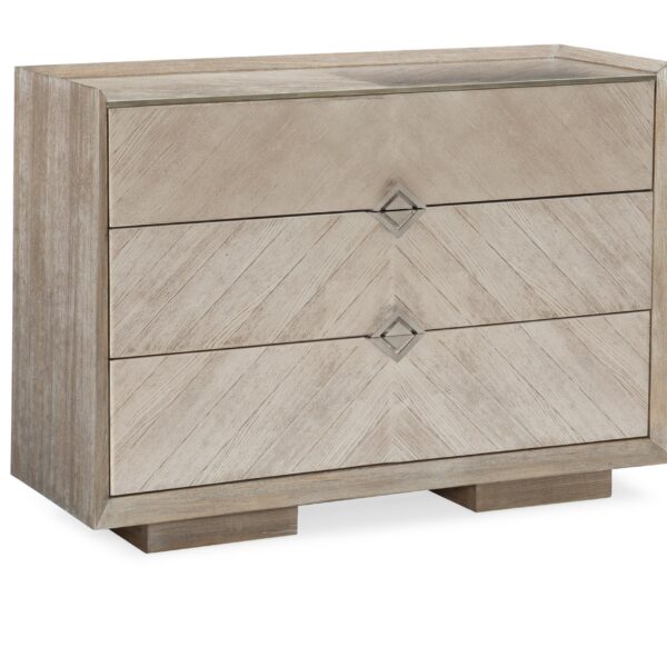 Caracole A NATURAL chest, featuring a striking chevron pattern created by meticulously matched wood grain veneers in varying driftwood tones.