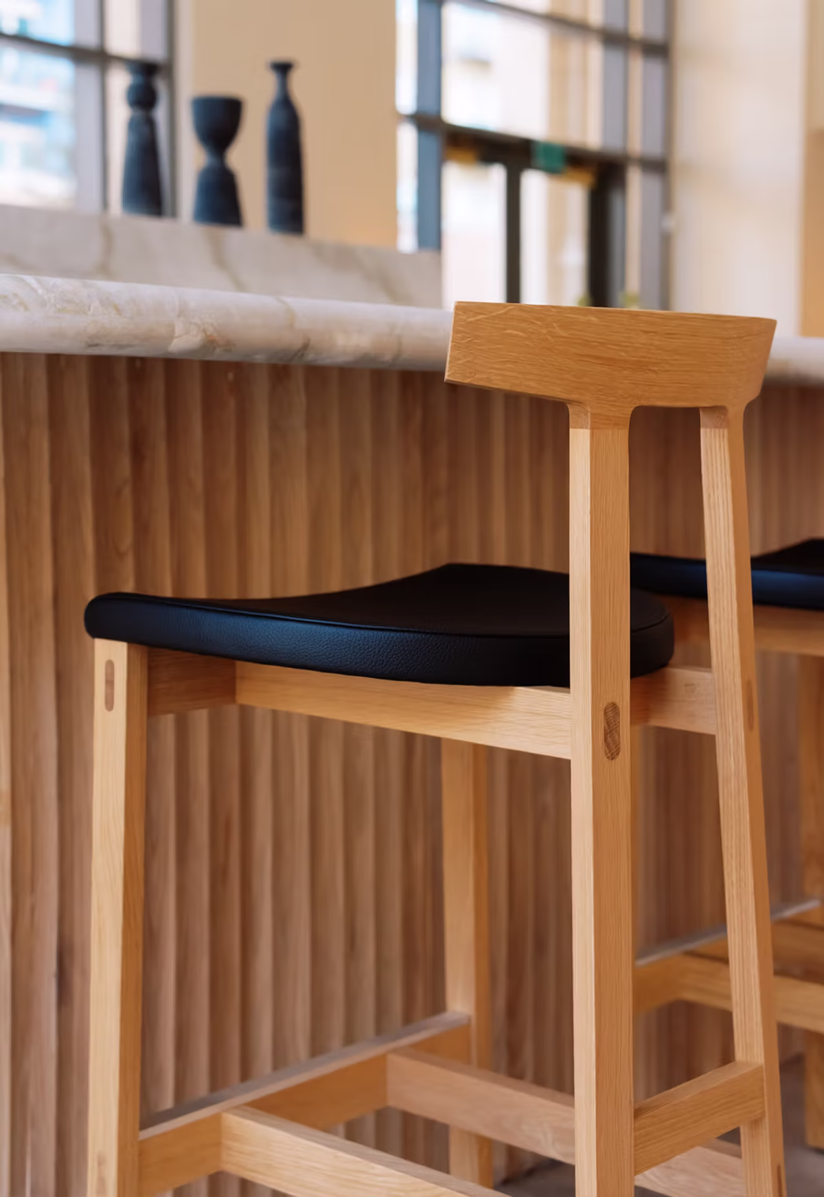 TORII Stool by Bensen, a versatile seating solution designed for both residential and commercial spaces, blending artistic form with practical functionality.