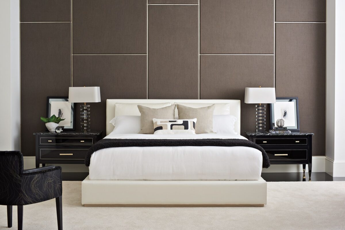 Luxurious upholstered bed with a modern, tailored headboard featuring subtle side wings, THE BOUTIQUE BED by Caracole.