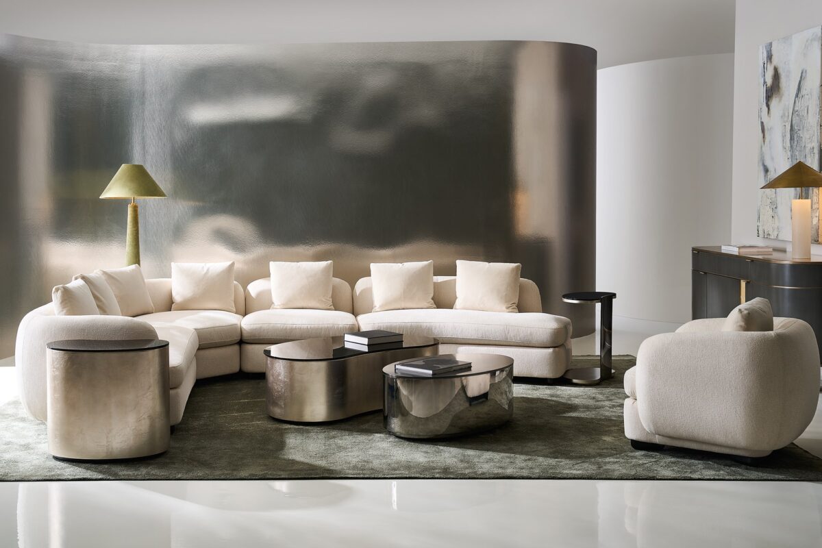 Modern oval coffee table featuring clean lines and a reflective tempered glass surface.