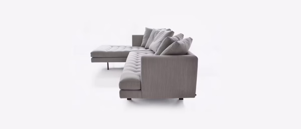 Modern sectional sofa featuring a sleek silhouette with button-tufted cushions and down-filled backrests.