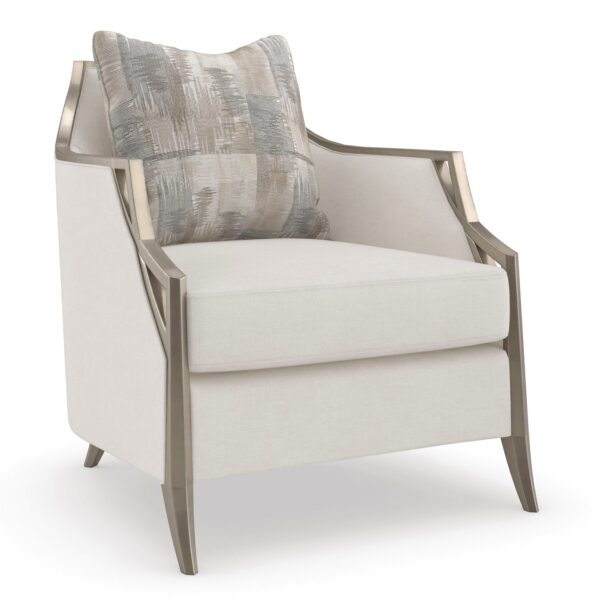 The Caracole X Factor Sofa, a modern classic upholstered in a herringbone performance fabric, featuring a wood-trimmed silhouette with a carved crisscross pattern, gently sloping arms, splayed legs in a metallic Charcoal Leaf finish, and feather-down toss pillows.