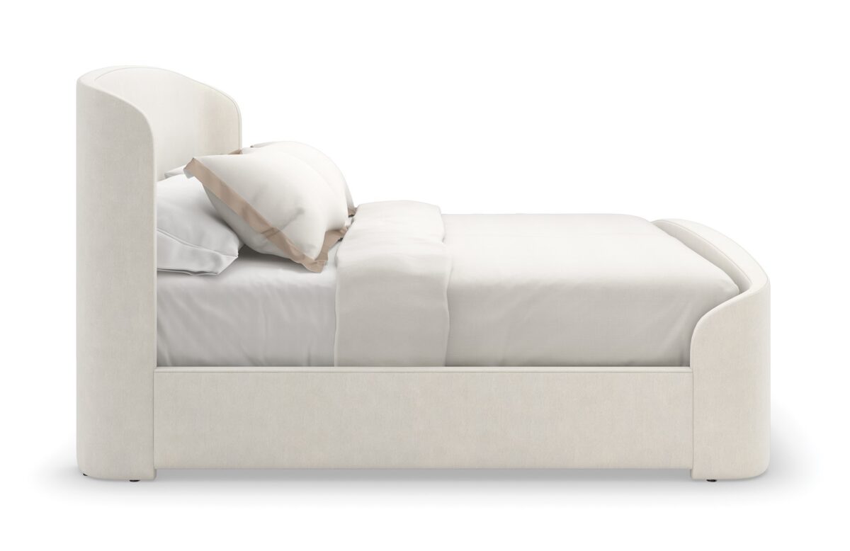 Caracole SOFT EMBRACE King Bed, featuring a tall, deeply tufted headboard that gently curves inward, creating a cocoon-like and inviting feel.