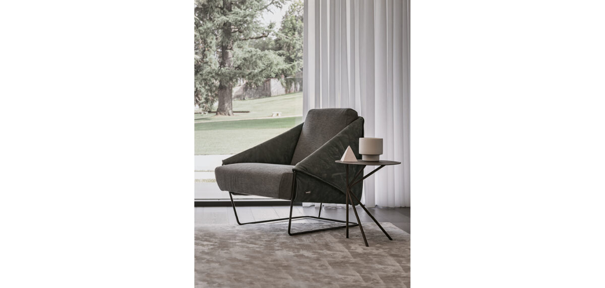 Fly Small side table by Nicoline Italia featuring a minimalist double K metal base and circular top, available in Satin Brass, Antique Bronze, or Mastice finishes.