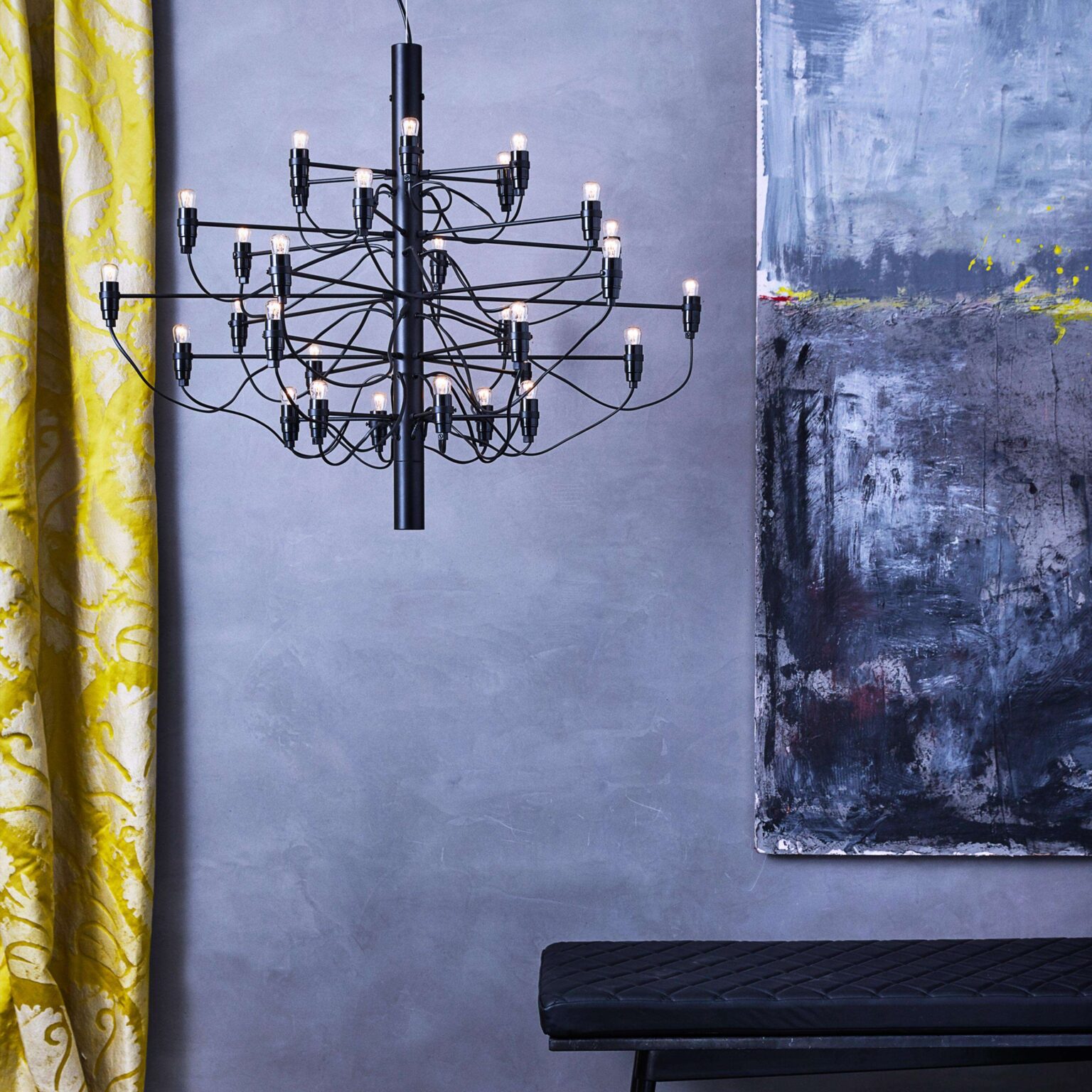 Flos 2097/30 pendant in matte black finish, its network of curved metal arms ending in soft-glow frosted bulbs.