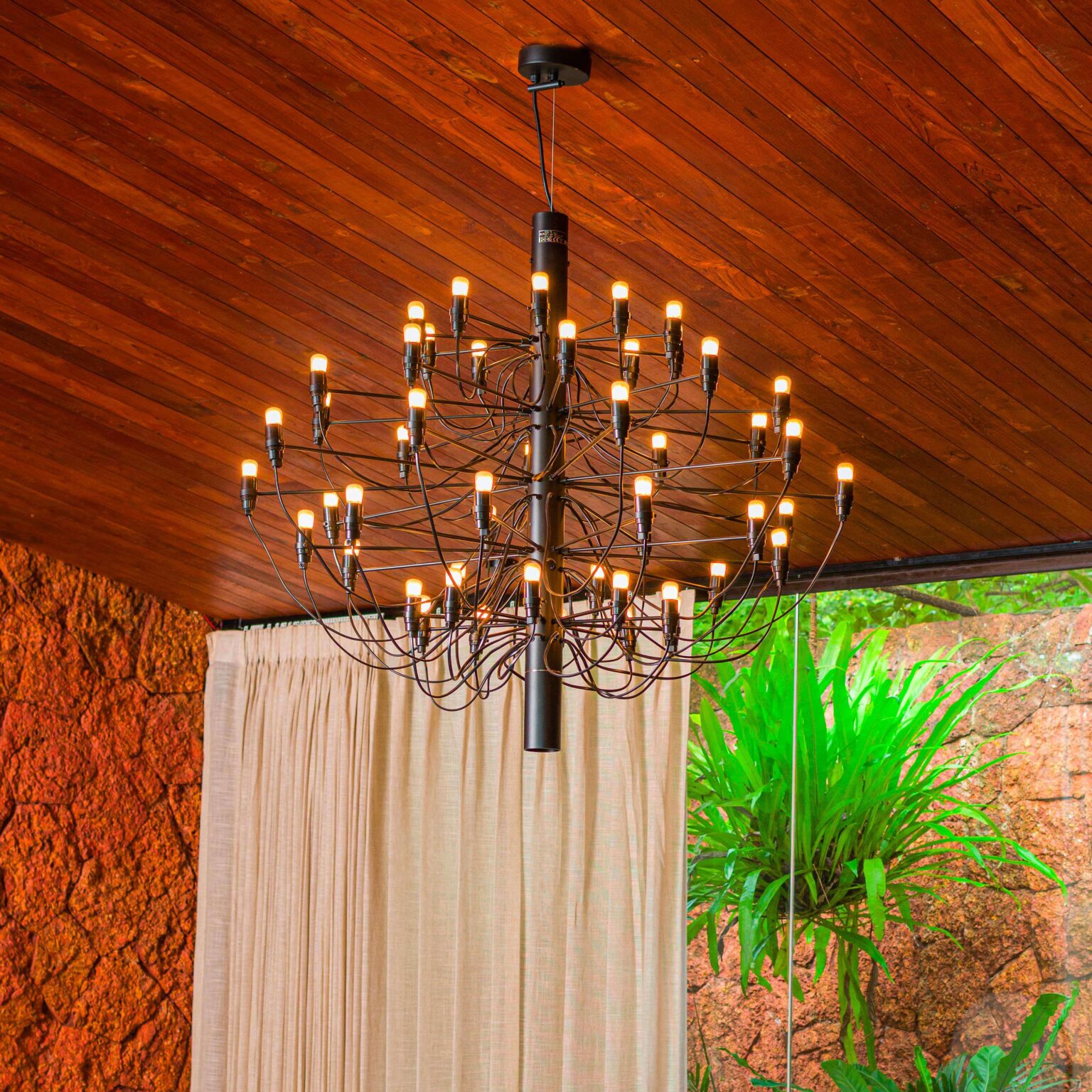 Close-up of cluster of clear glass bulbs on the 2097/50 chandelier, each on slender brass arm extending from central hub.