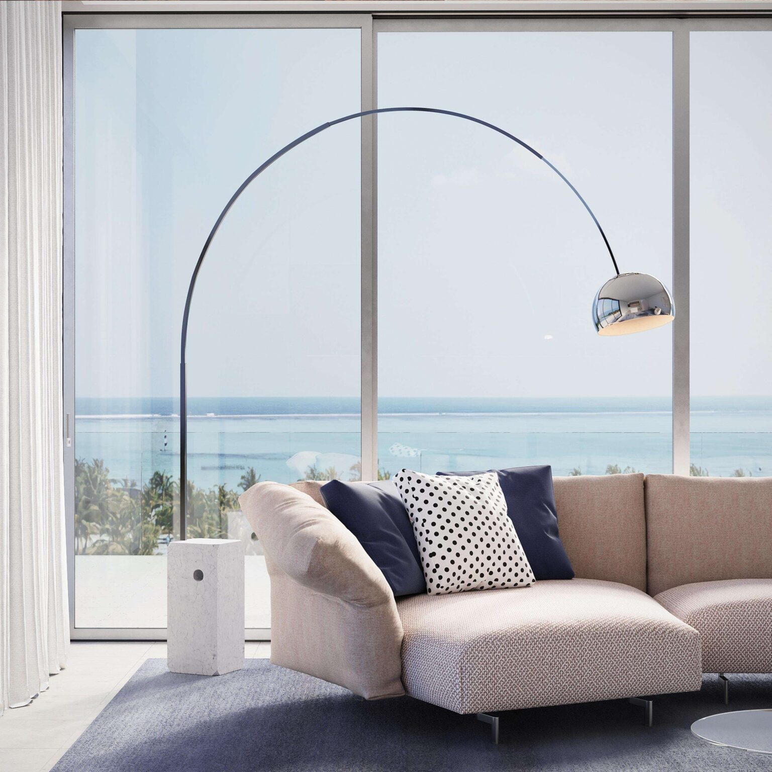 Flos Arco LED with elegant curved stainless-steel arm extending over a sofa, overhead reflector pendant in satin finish.