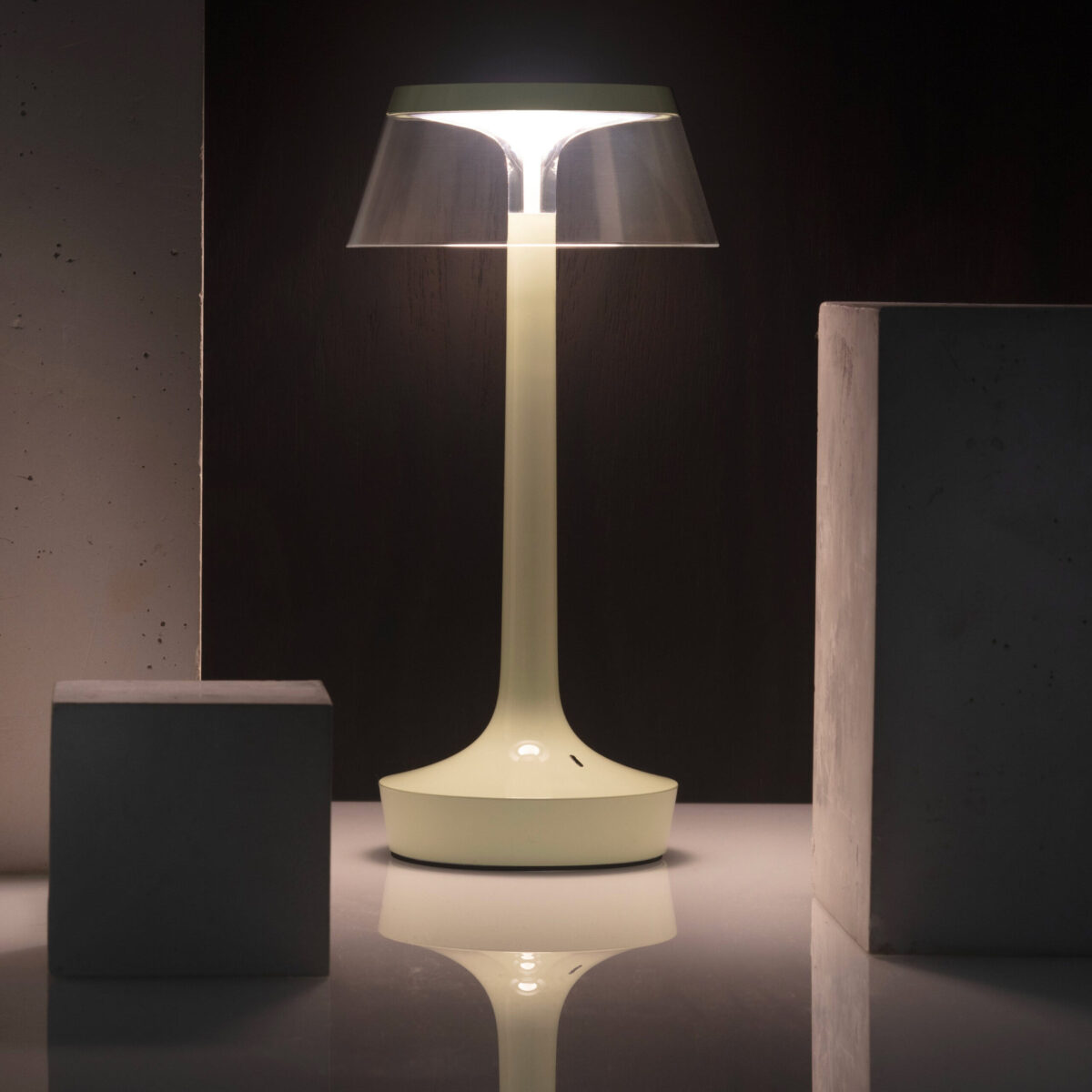 Rechargeable LED table lamp with sleek silhouette and touch control, Bon Jour Unplugged by Flos in chrome finish.