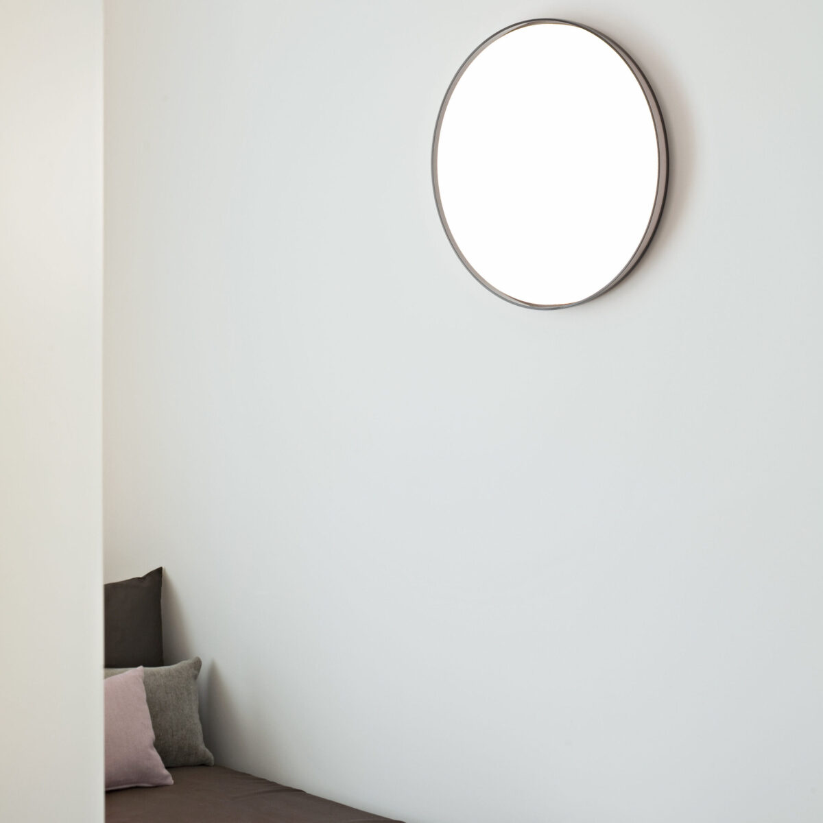 The elegant Flos Clara light, designed by Piero Lissoni, a thin, round fixture featuring a central opal diffuser and an optional decorative ring in a finish like [e.g., "chrome" or "black fumée"].