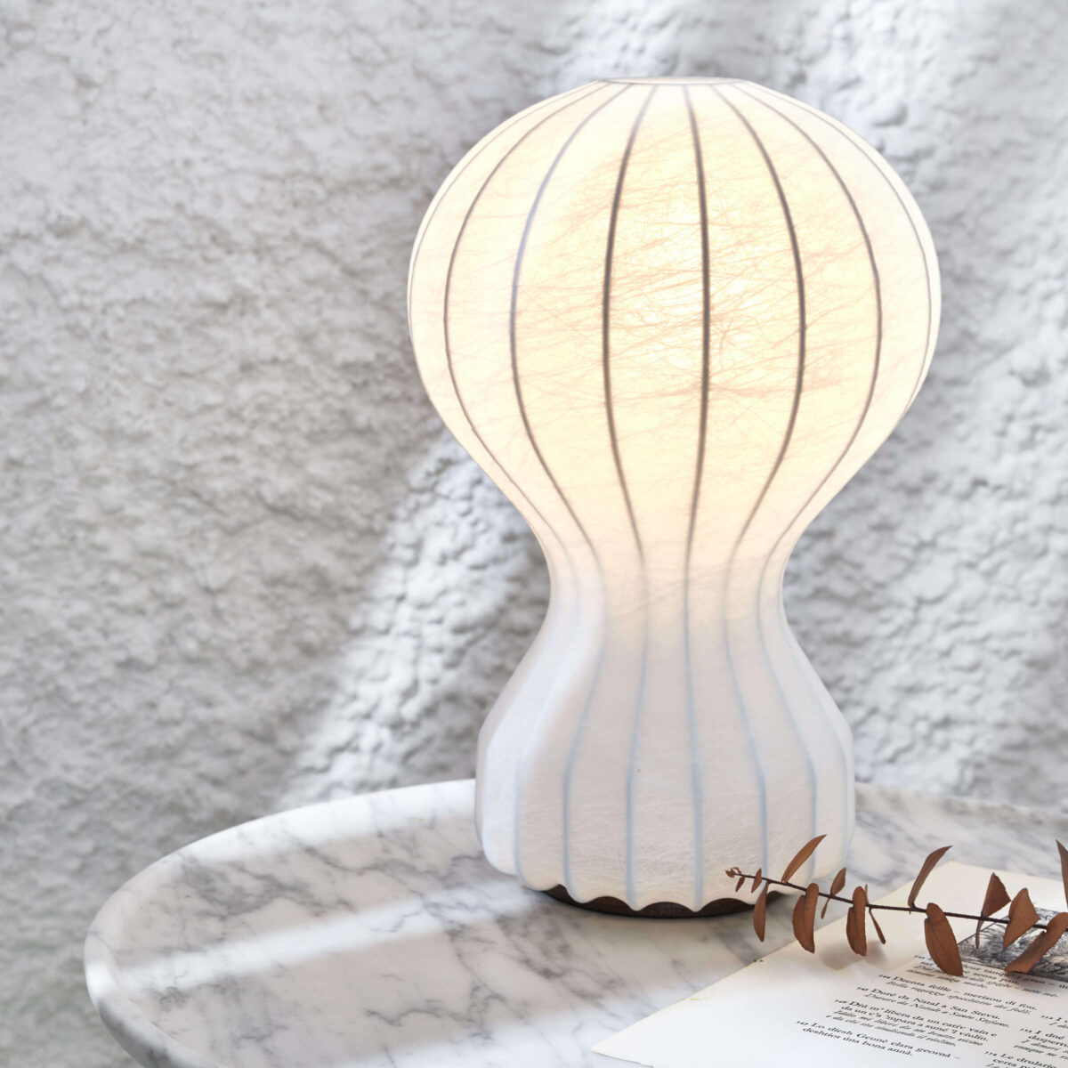 Gatto Piccolo Table Lamp by Flos showcasing white powder-coated steel structure encased in transparent resin at the Michigan Design Center