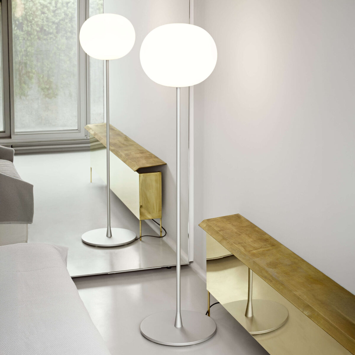 Matte black Glo‑Ball Floor 2: spherical diffuser on a thin black-painted steel column with integrated cable dimmer.
