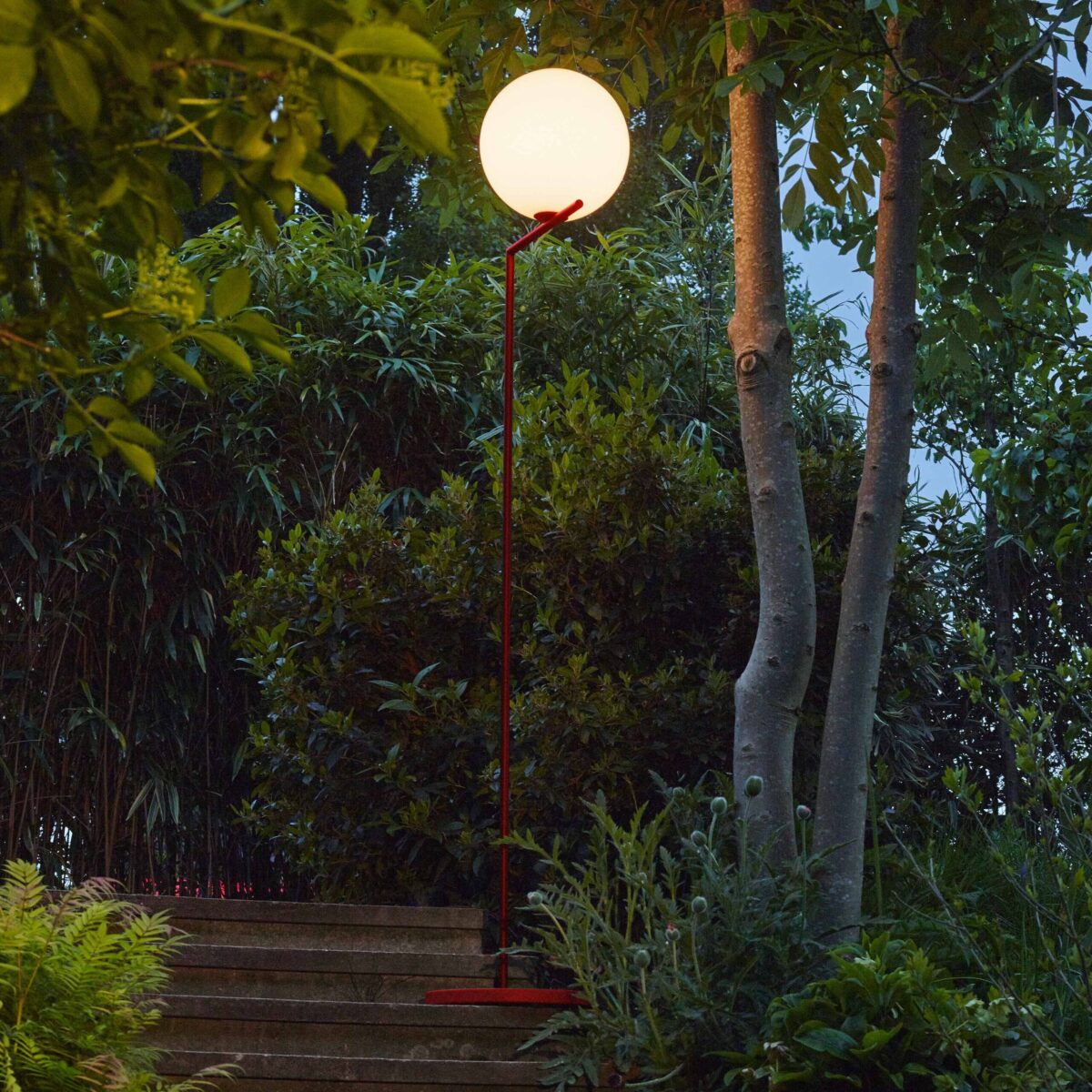 IC F1 Outdoor by Flos in brushed brass finish, with a glass globe delicately suspended on a slim stem.