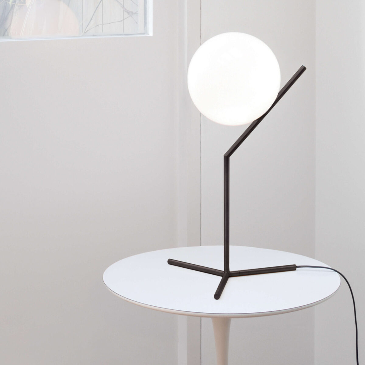 IC Lights T1 High Table Lamp by Flos showcasing a dimmer-integrated cord and brass-plated steel frame at the Michigan Design Center