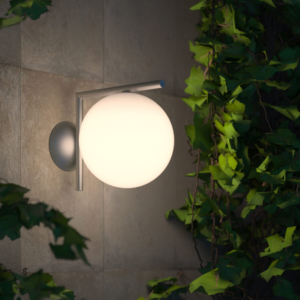 Compact outdoor wall light with elegant globe design, IC C/W1 by Flos in black finish.