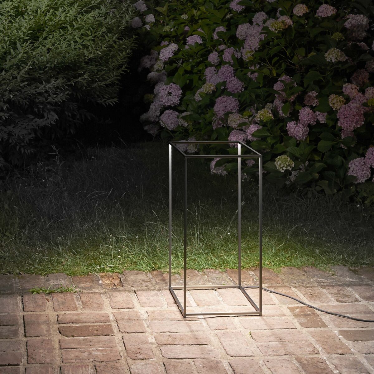 Modern outdoor lantern-style lamp with an open box design, Ipnos by Flos in anodized black finish.