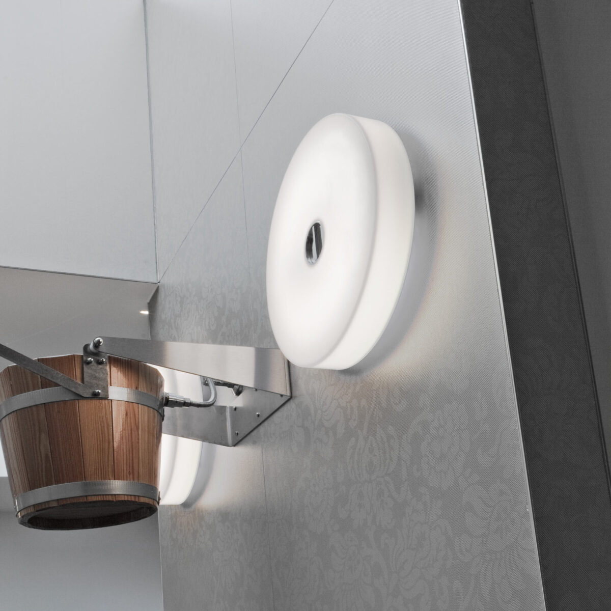 A contemporary Flos Button HL light in white, showcasing its simple yet elegant button-like form, ideal for blending into modern residential or commercial interiors.