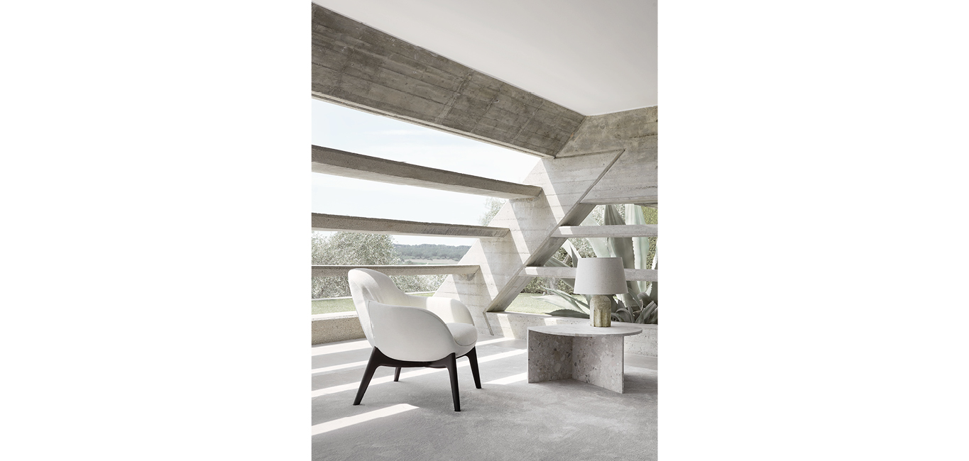 Ghirla armchair by Nicoline Italia with elegant curves and wooden base, perfect for modern interiors in Royal Oak, Michigan.