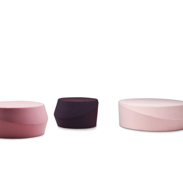 "Pouf Tour by Casamania in bright orange fabric, placed in a modern living room as extra seating."