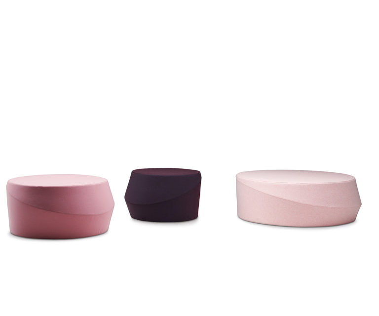 "Pouf Tour by Casamania in bright orange fabric, placed in a modern living room as extra seating."