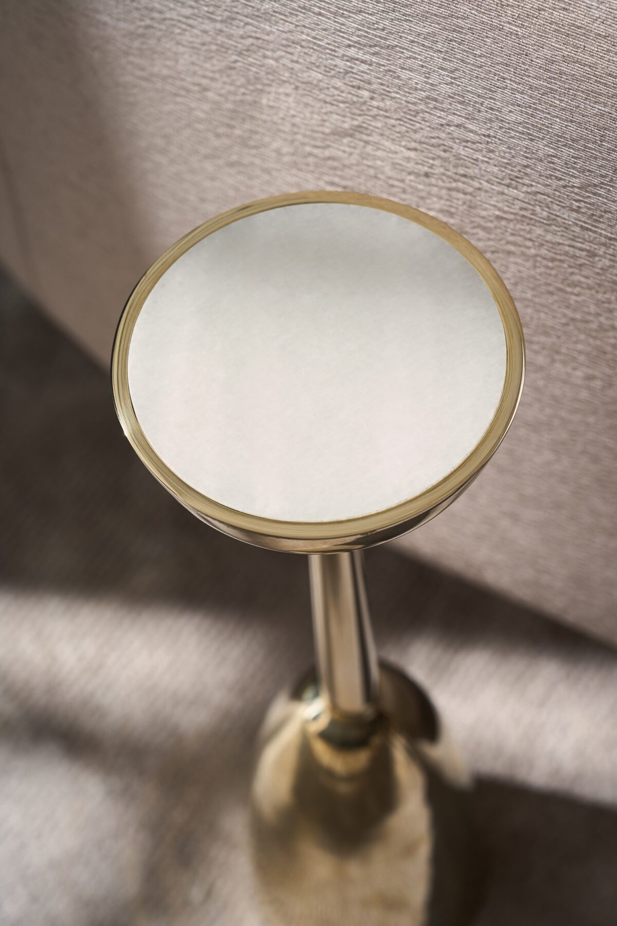 Gamma Accent Table by Caracole – Sleek mid-century-inspired design featuring a Guangxi white stone top and Whisper of Gold metal base.