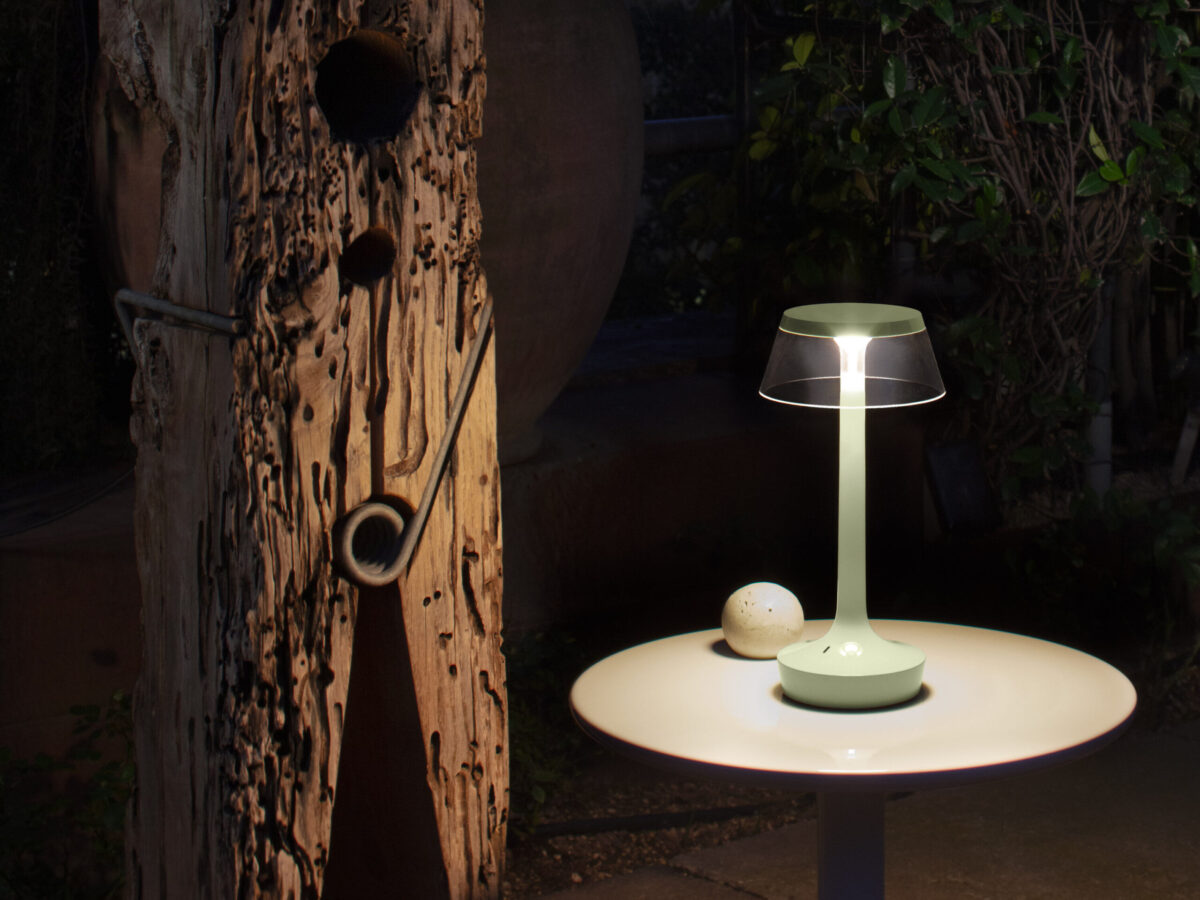 Flos Bon Jour Unplugged lamp with transparent body and minimalist shade, offering warm, portable lighting.