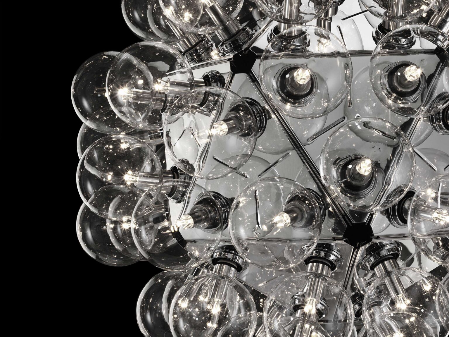 Flos Taraxacum 88 lamp in a modern lobby, casting warm, radiant glow from its globe-like suspended form.