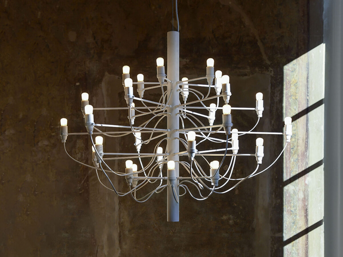 Suspended 30-light chandelier with polished steel frame and transparent bulbs, Flos 2097/30 over a modern dining table.