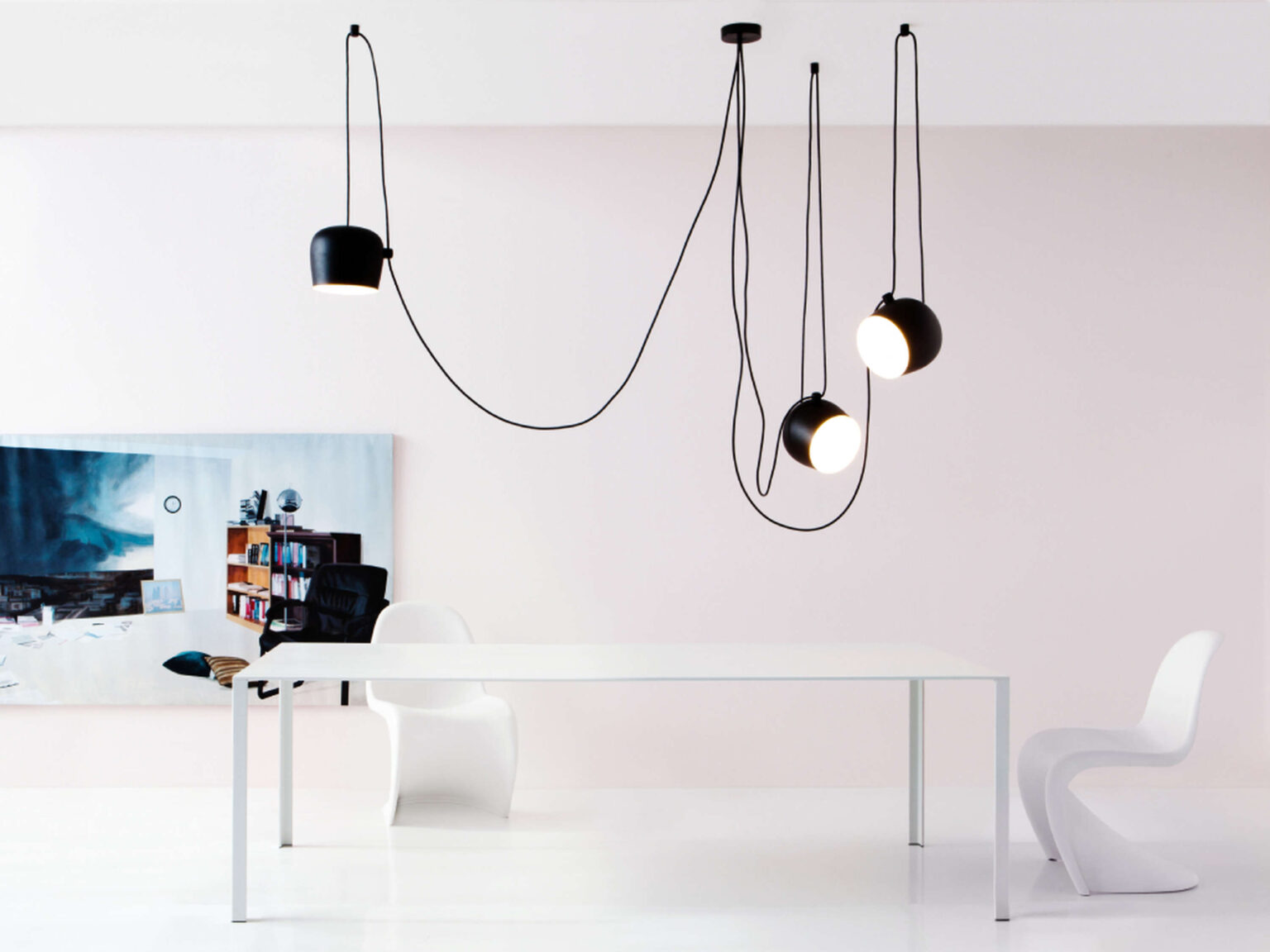 Three‑light configuration of Aim pendant in black, presenting sculptural asymmetry through varied head orientations.