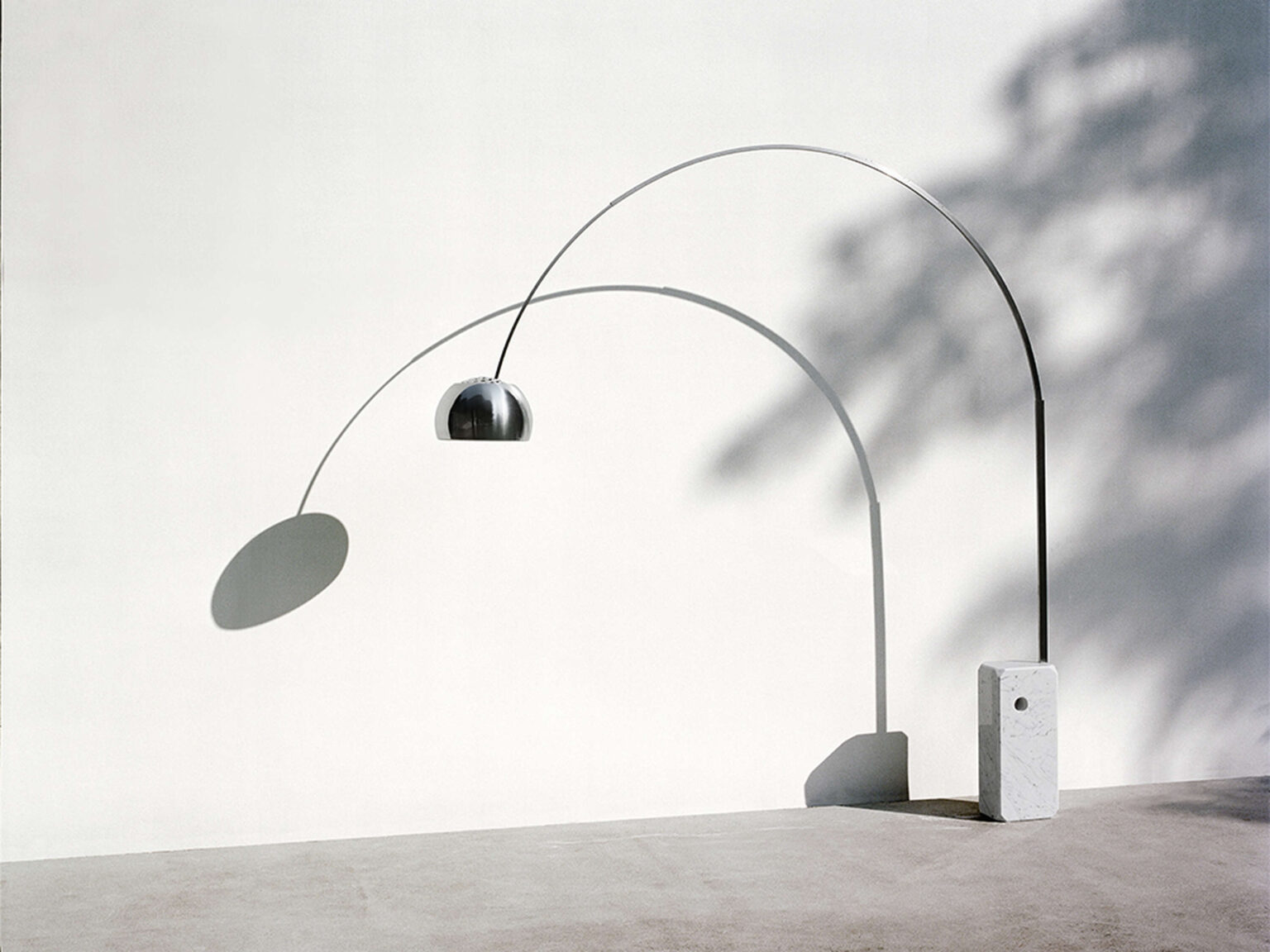 "Close-up of the Arco LED’s spun aluminum reflector with perforated top for heat dissipation, adjusting via integrated swivel."