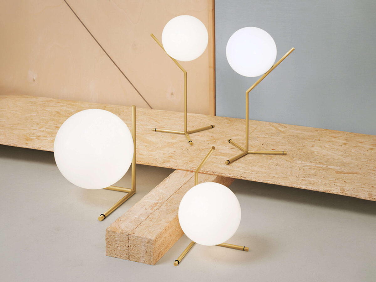 Contemporary bedside lamp with a floating globe design, IC Lights T2 by Flos adding ambient glow to a bedroom.