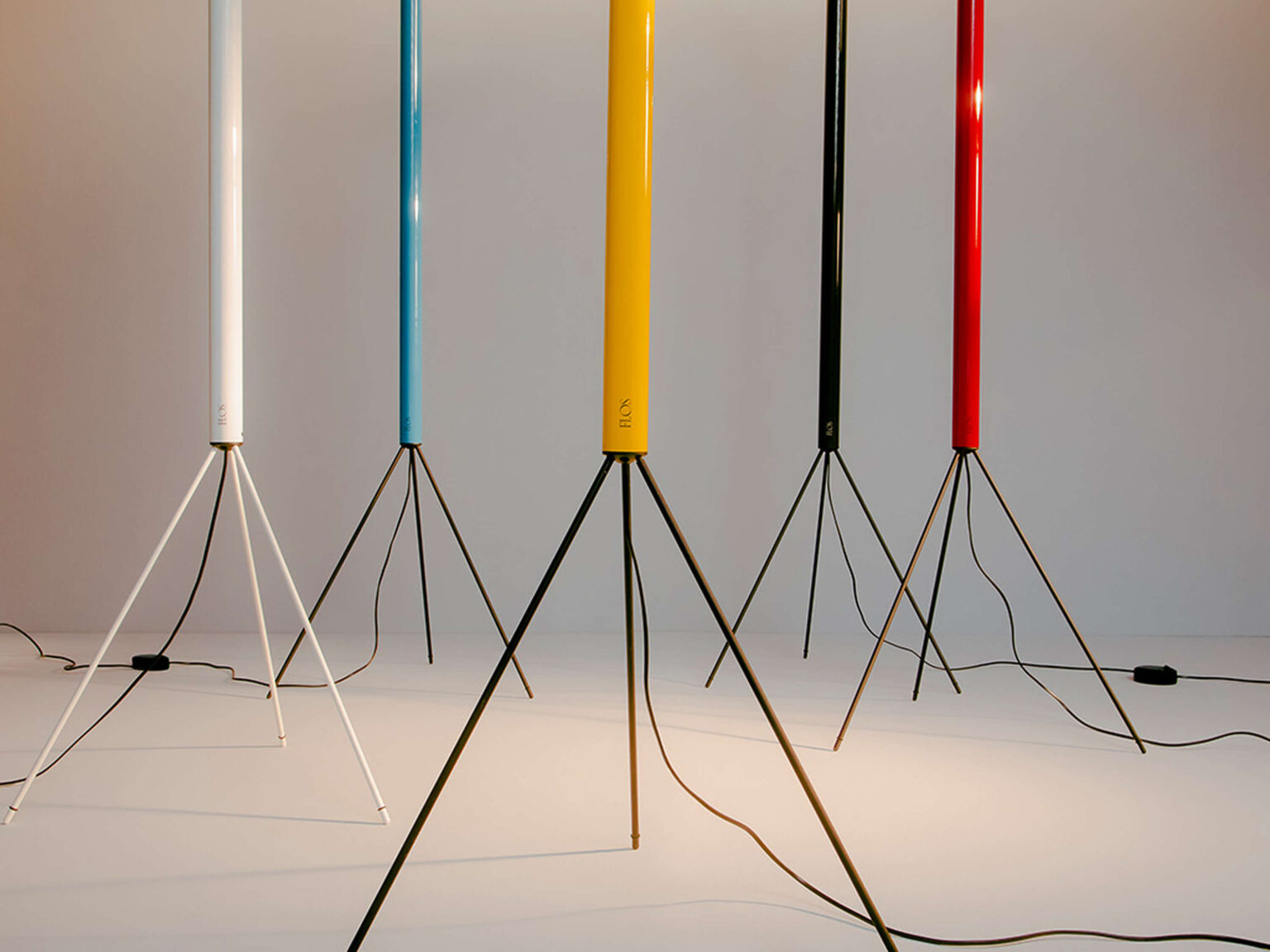 Slim Luminator lamp in yellow finish, featuring a round opal reflector on a painted iron stem with fine wire tripod base.