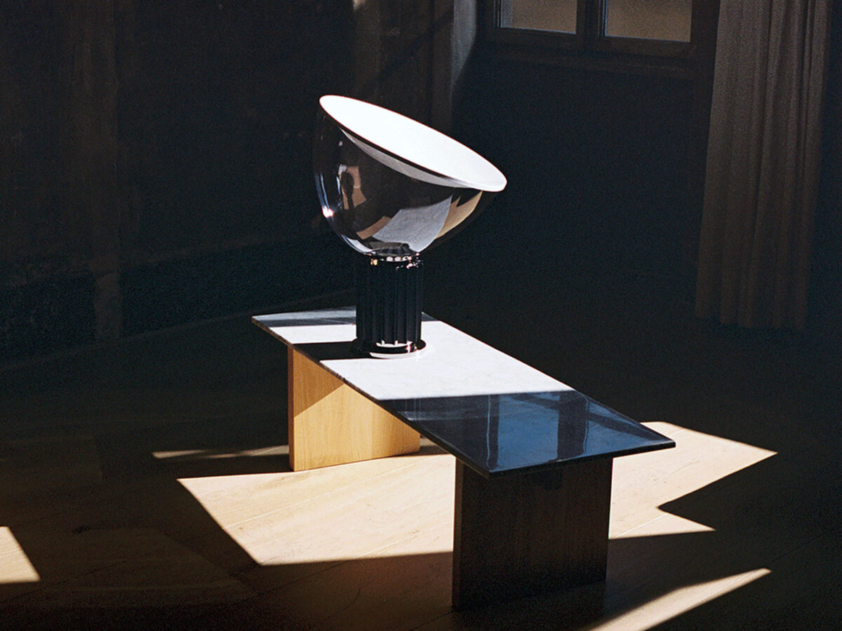 Taccia Small Table Lamp by Flos side profile highlighting the rotating transparent blown-glass diffuser in a Troy Michigan setting