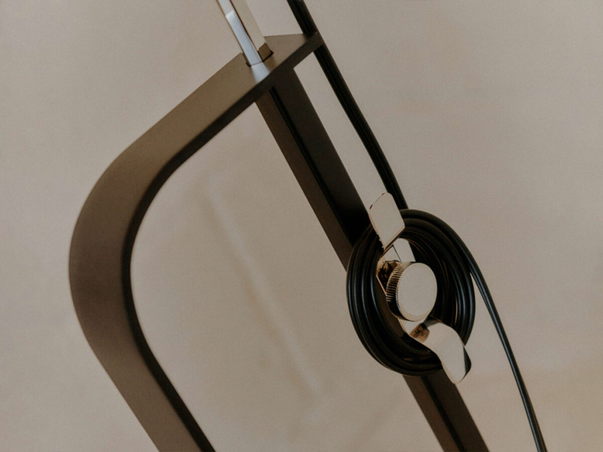 Toio Limited Edition Matte Black by Flos side profile highlighting adjustable height and integrated dimmer cable in a Troy Michigan setting