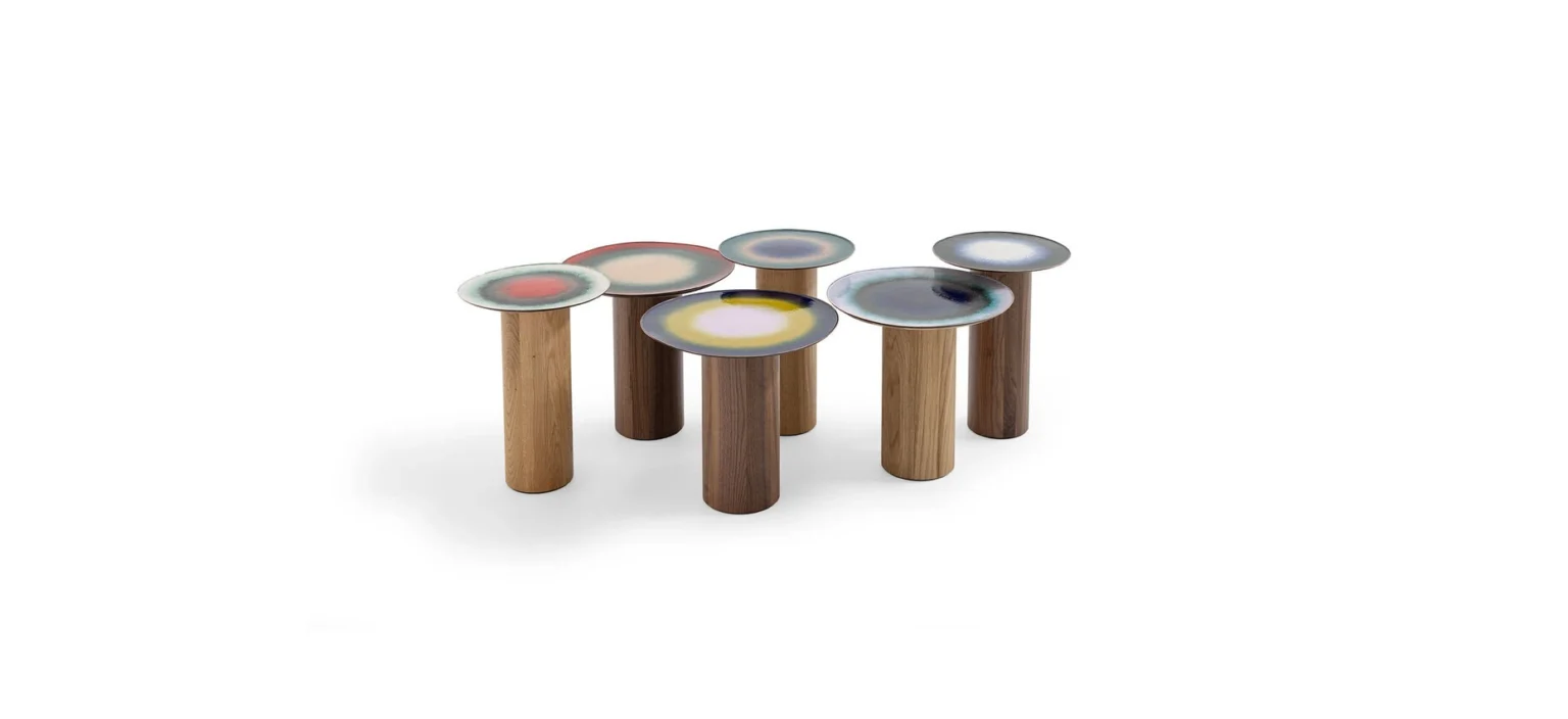 Fire Eater Small Table by Moroso showcasing unpredictable multi‐hued vitreous powder enamel on copper and walnut cylindrical support at the Michigan Design Center