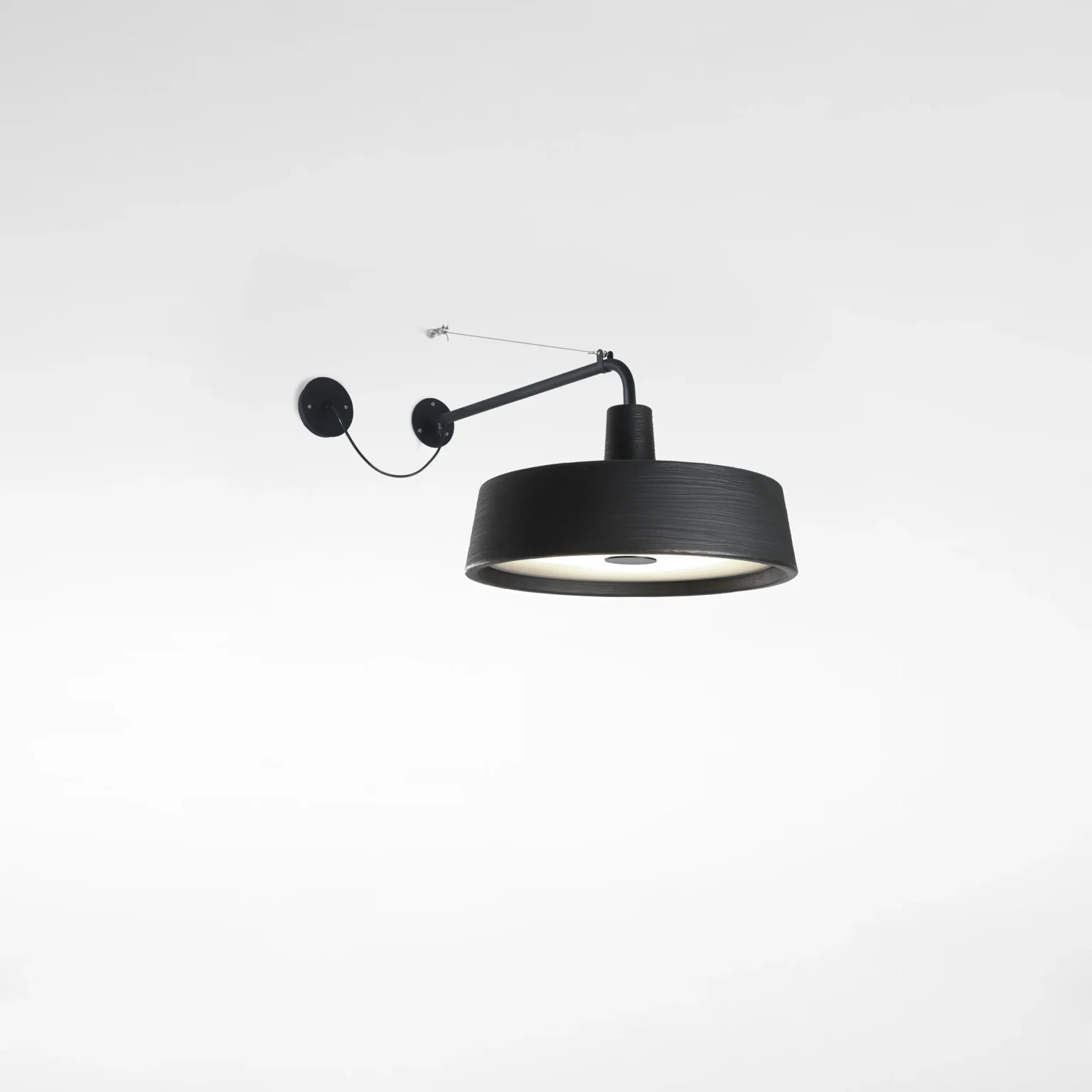“Soho by Marset wall-mounted exterior light – sleek circular fixture with soft ambient illumination”
