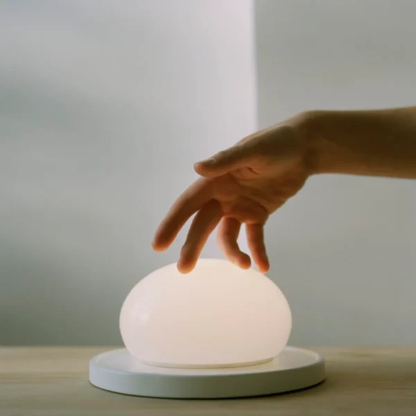 “Marset Bolita lamp – elegant round LED light with sliding mechanism for dimmable effect”