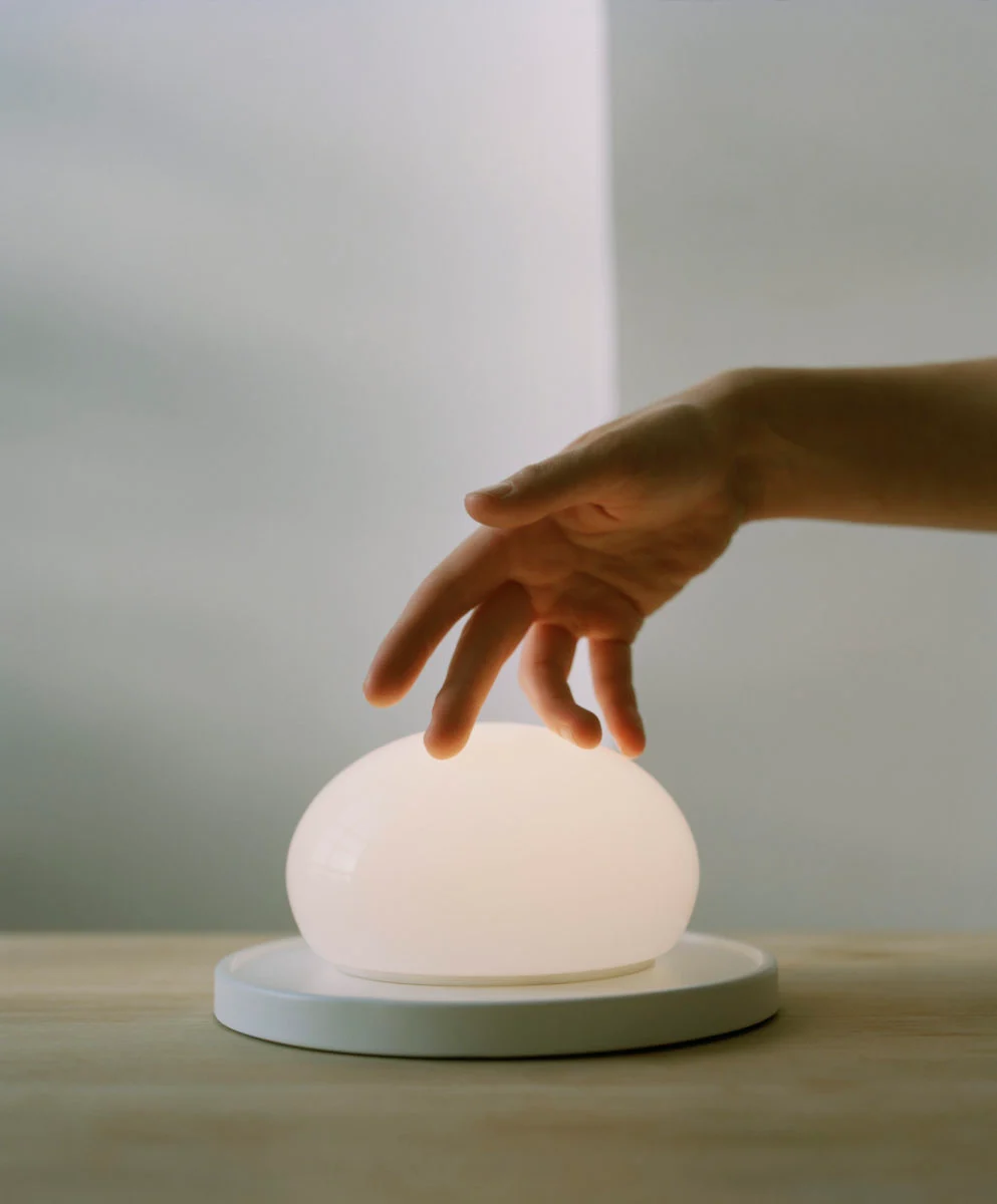 “Marset Bolita lamp – elegant round LED light with sliding mechanism for dimmable effect”