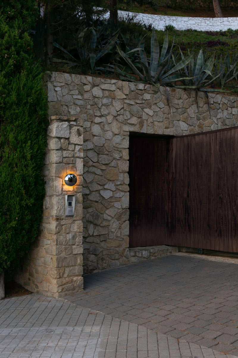 “Babila by Marset sculptural outdoor wall lamp – modern design with mirrored steel and soft illumination”