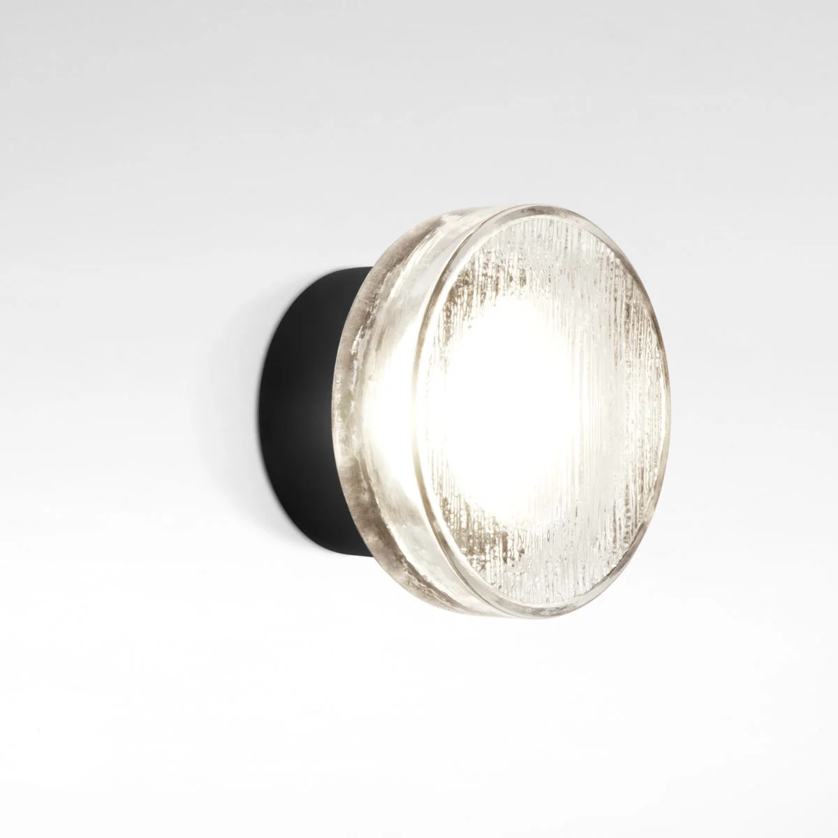 “Roc by Marset wall lamp – compact aluminum fixture with pressed glass diffuser featuring organic, ice‑like texture”