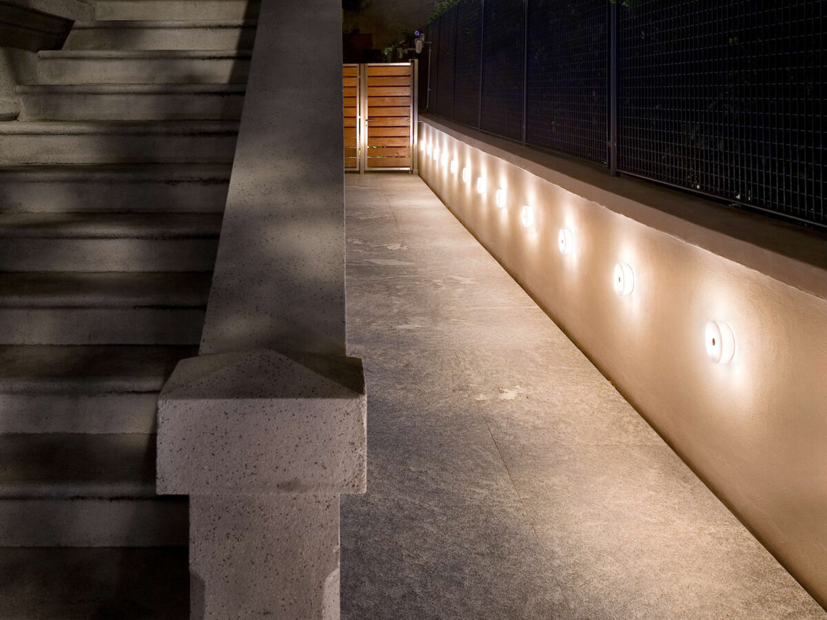 Modern and discreet, the Flos Mini Button lamp, with its smooth, matte white glass or polycarbonate surface, designed to emit a gentle, even glow when installed.