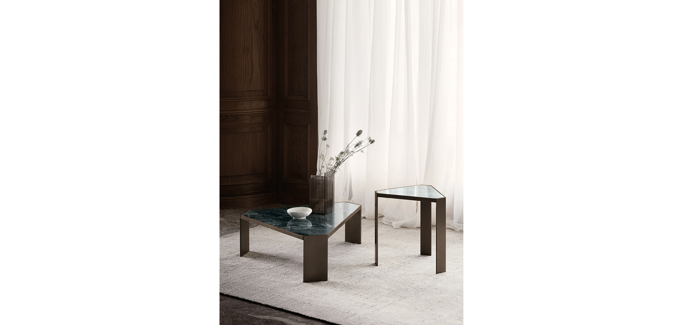Fly Small side table by Nicoline Italia featuring a minimalist double K metal base and circular top, available in Satin Brass, Antique Bronze, or Mastice finishes.