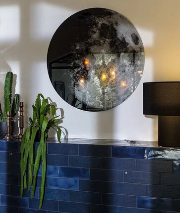 My Moon My Mirror by Moroso side angle highlighting slender support column and contemporary round design in a Troy Michigan setting