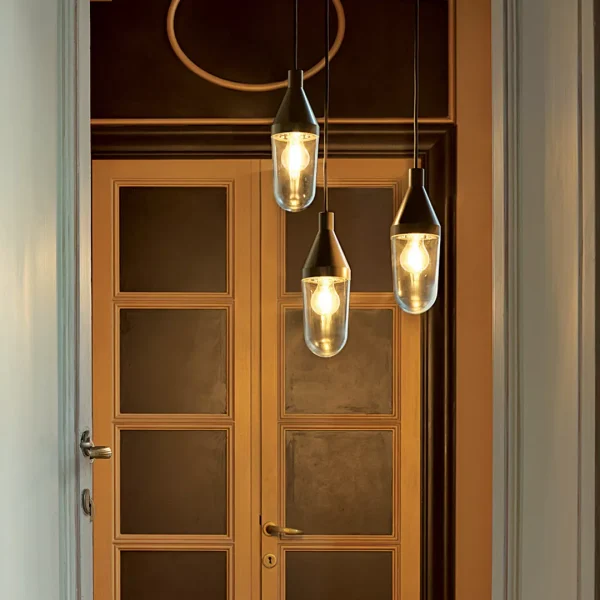 “Niwa by Oluce modern Italian pendant light – sleek cylindrical metal body with diffused LED light and minimalist suspension design”