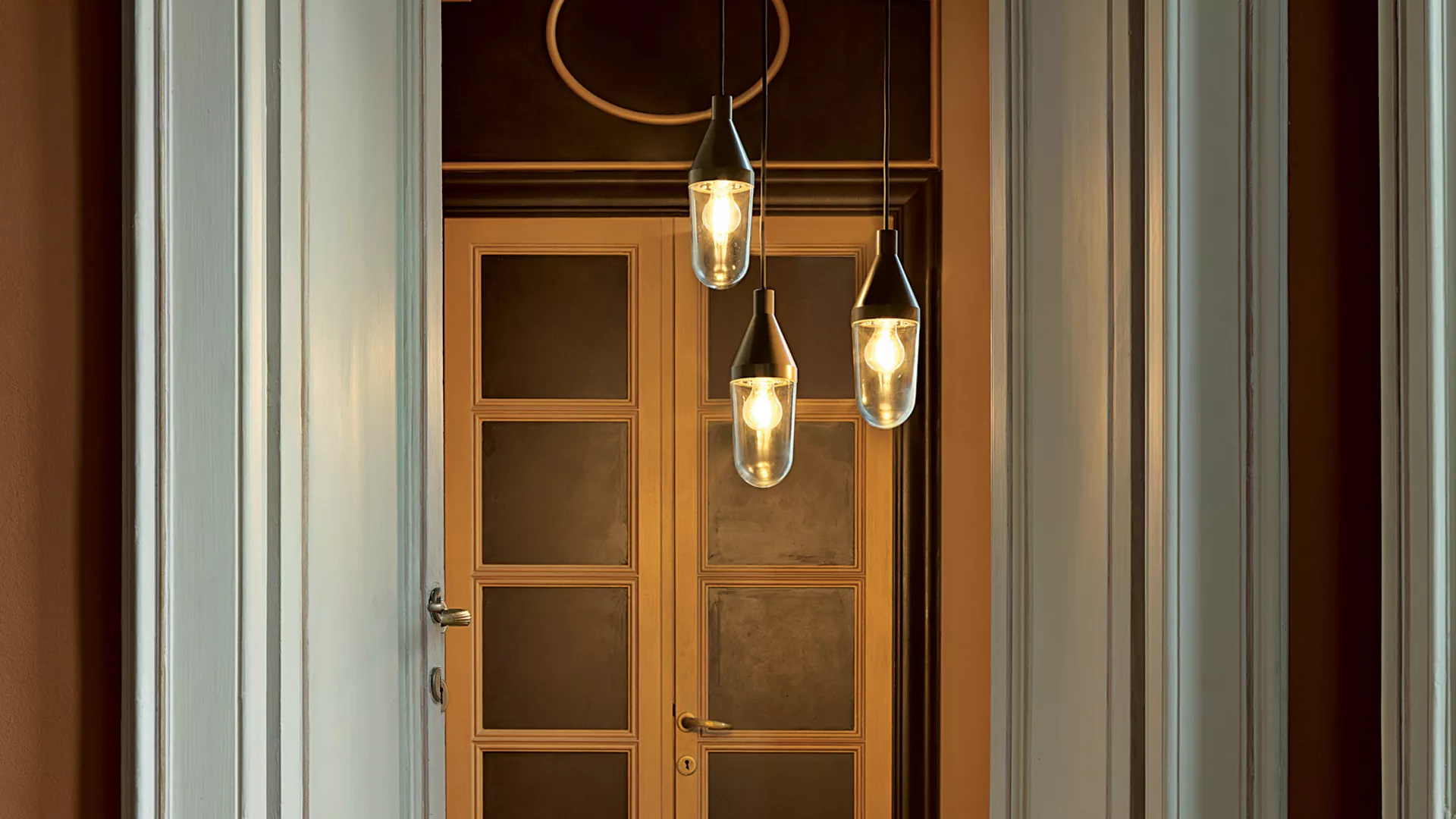 “Niwa by Oluce modern Italian pendant light – sleek cylindrical metal body with diffused LED light and minimalist suspension design”