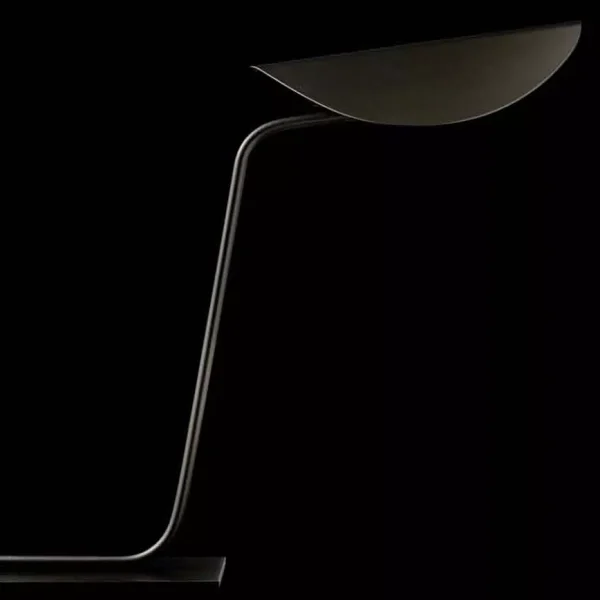 “Plume by Oluce modern Italian wall lamp – sleek metal fixture with curved blade-like diffuser and minimalist design”