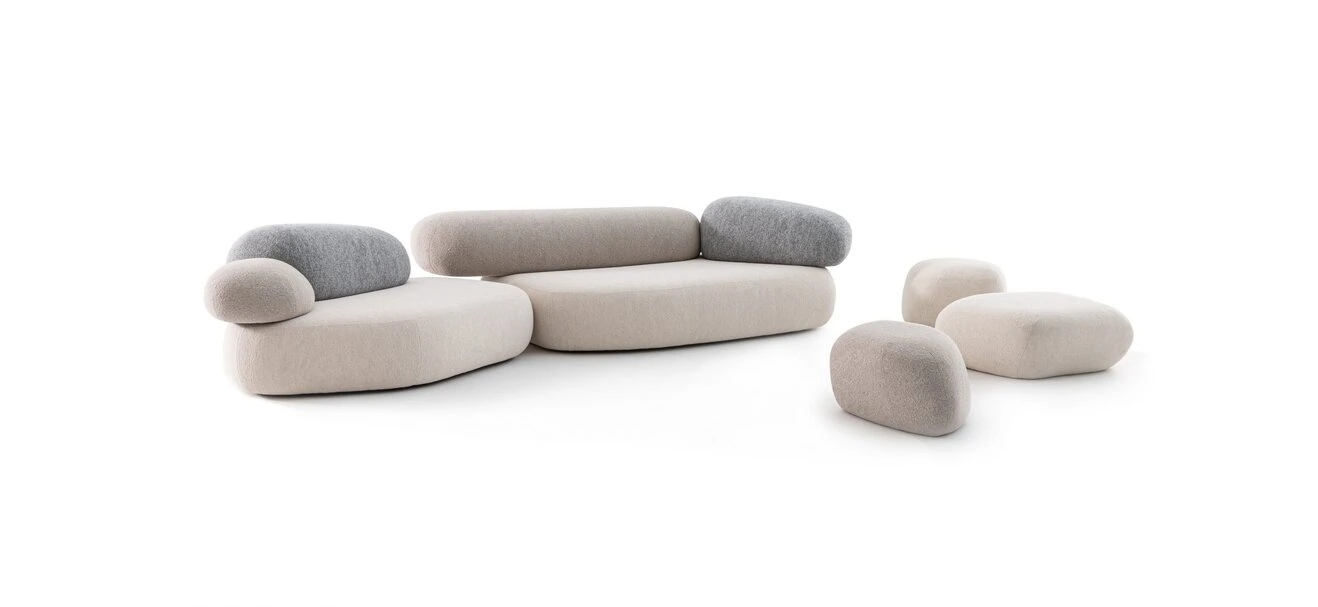 Pebble Rubble pouf by Moroso in soft beige fabric, resembling a smooth stone, placed in a modern living room