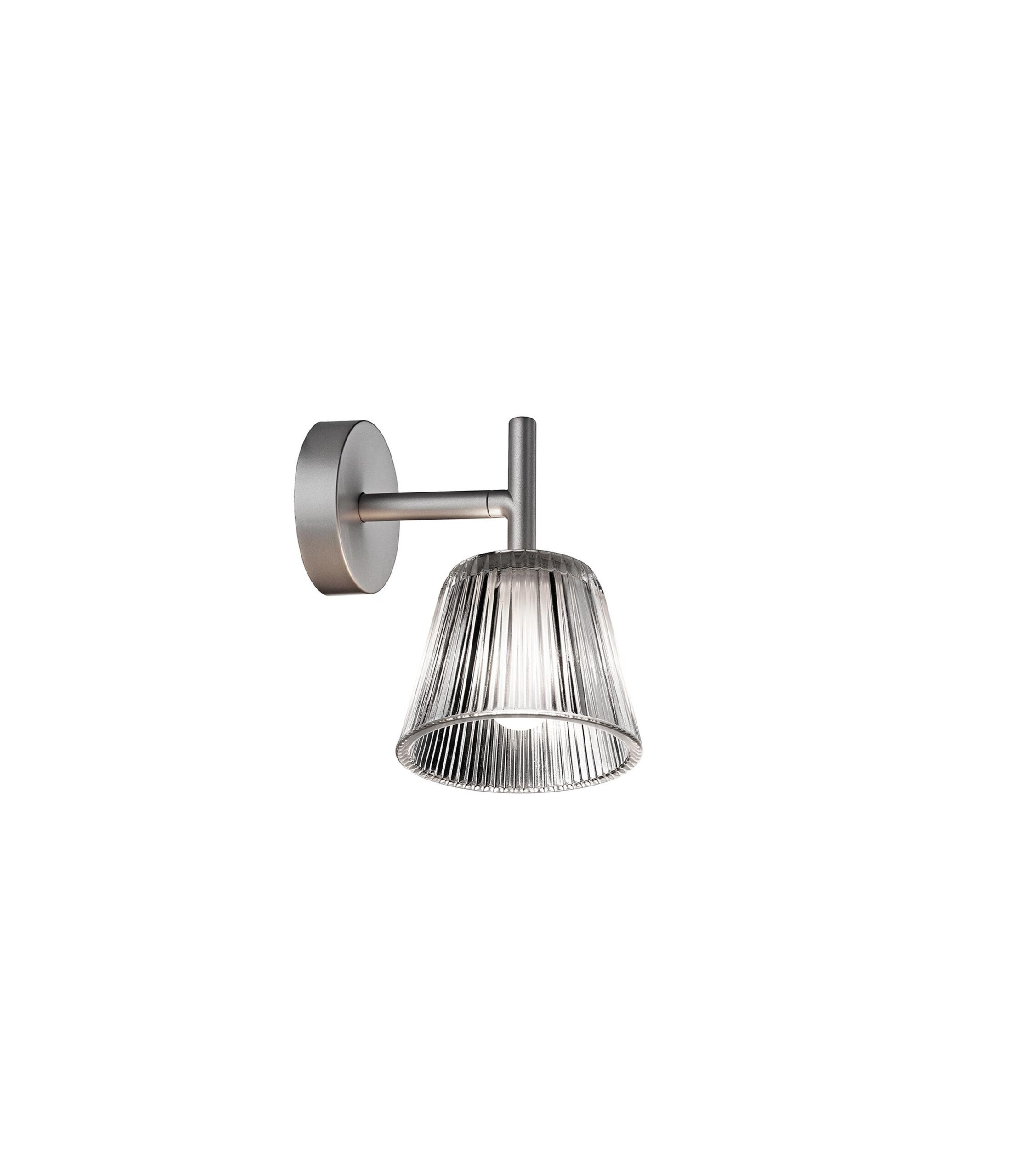 A contemporary Flos Romeo Babe Wall lamp with a [specify outer shade: "pleated fabric" or "clear glass"] shade, and an internal acid-etched glass diffuser, providing soft, diffused light.